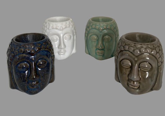 Four ceramic face-shaped vases on a white surface with a light gray background